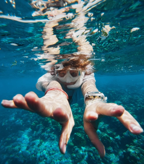 A diver swimming through clear tropical water